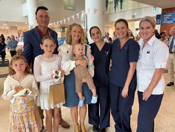 family and staff standing in the reception of the Tweed Valley Hostpital