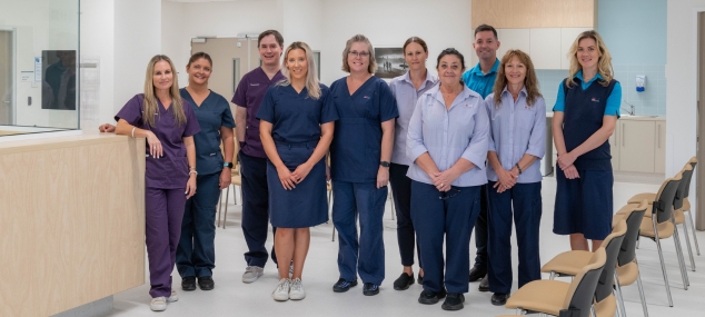 A team of people gathered in the reception of a hospital