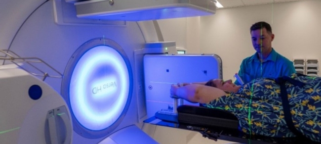Female patient lying down awaiting to be put through a radiology machine
